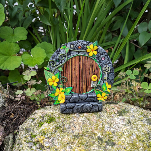 Hobbit door with yellow flowers and...
